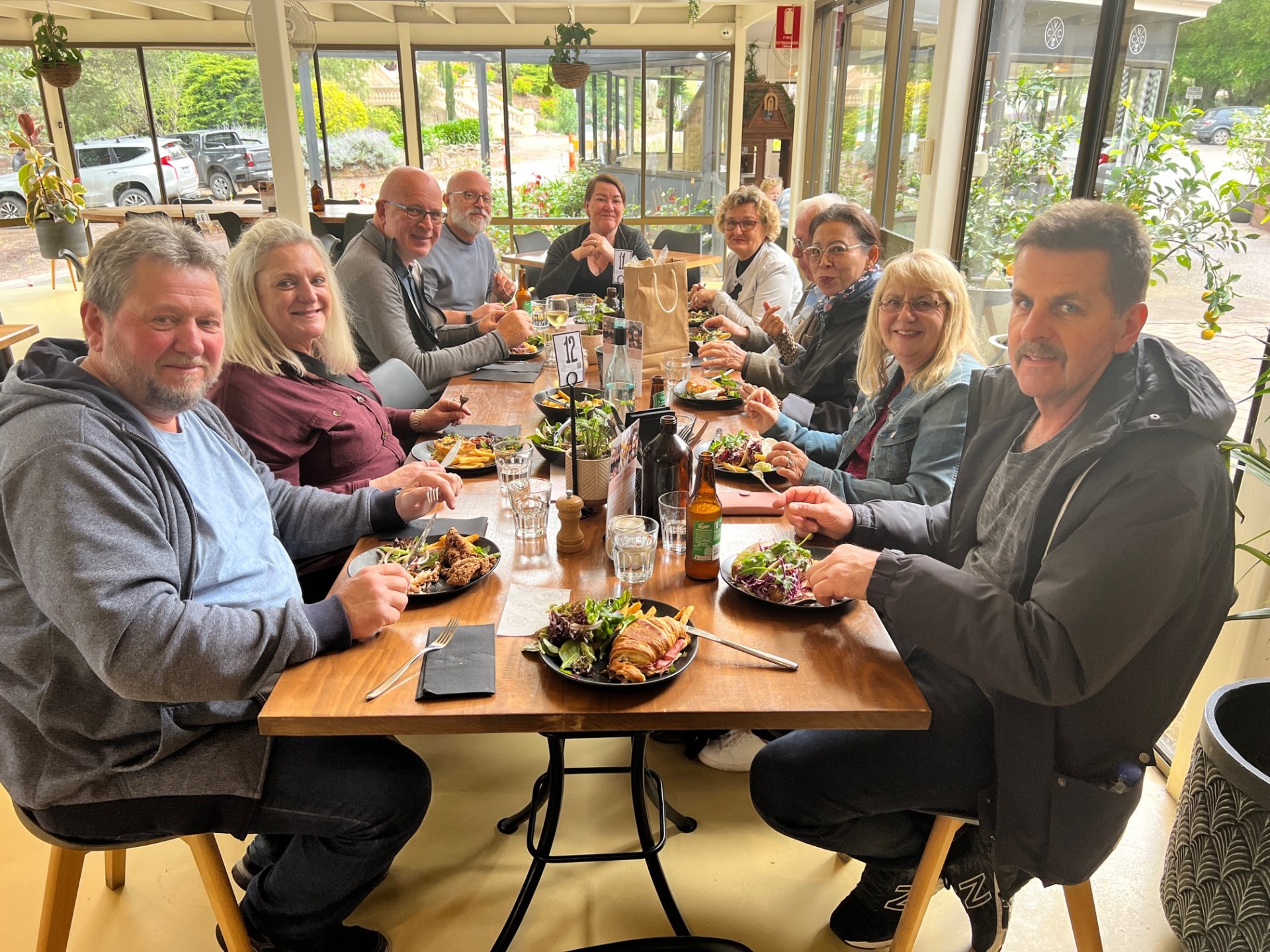a group of people sitting at a table eating food