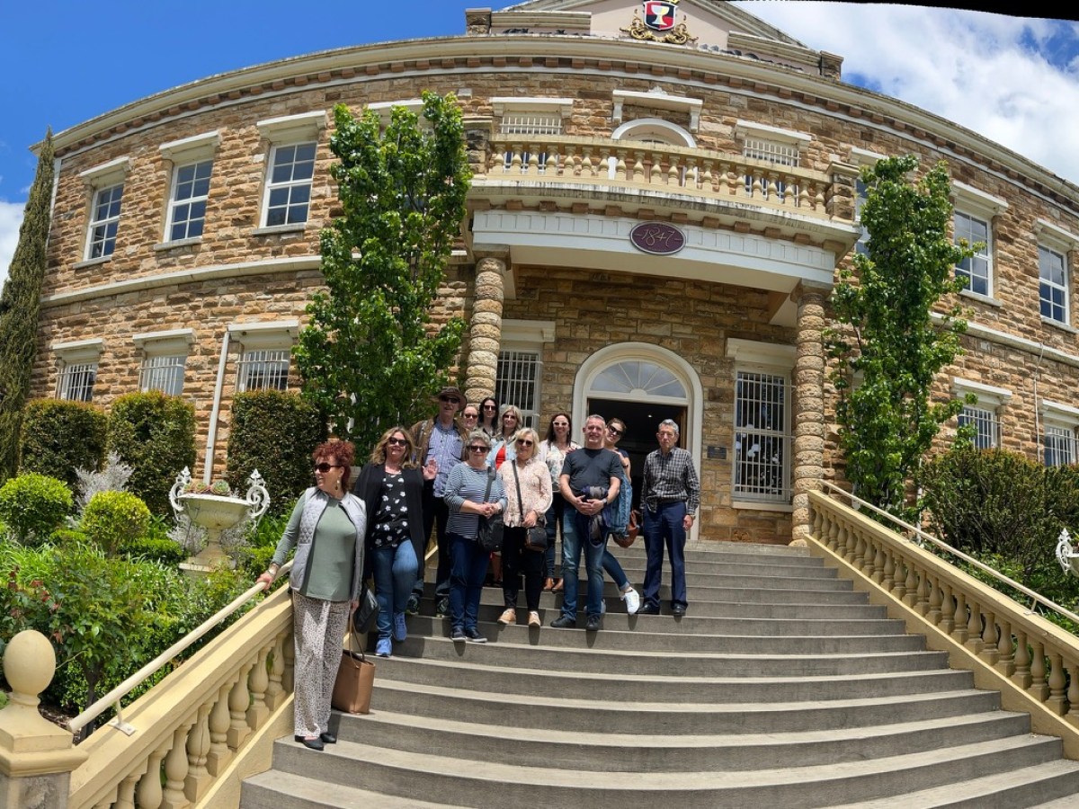 a group of people walking in front of a building