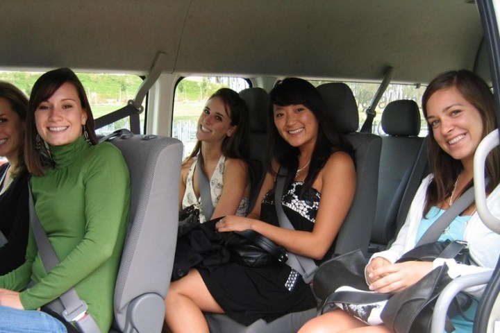 a group of people sitting in a car posing for the camera