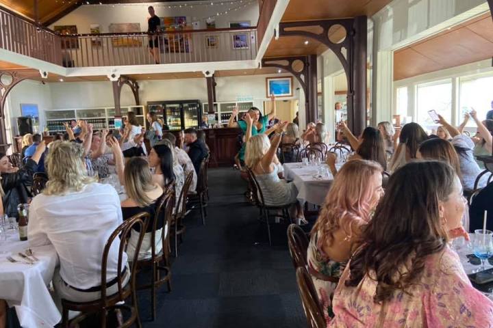 a group of people sitting at a table in a restaurant