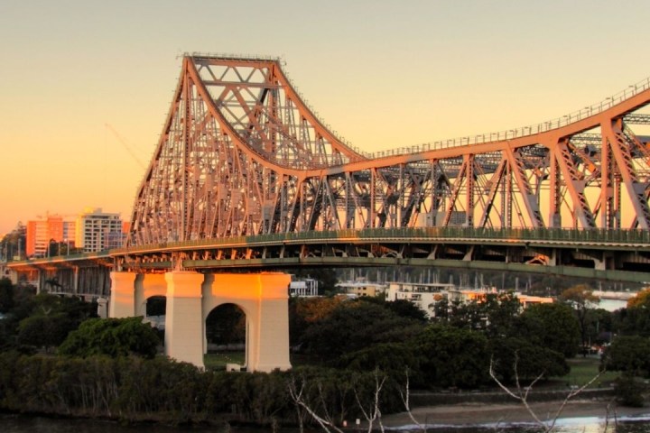 a train crossing a bridge over a body of water