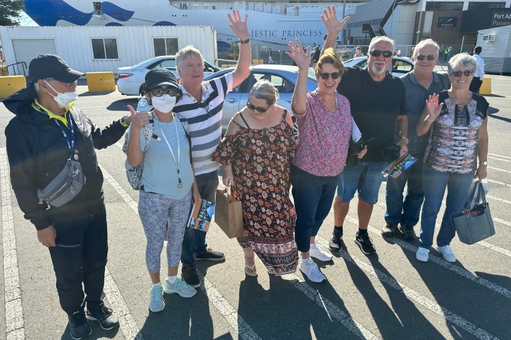 a group of people standing in front of a crowd posing for the camera