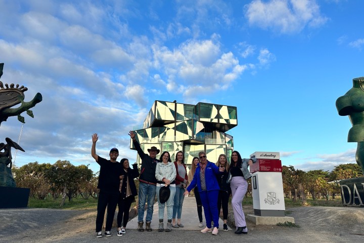 a group of people standing around a fire hydrant