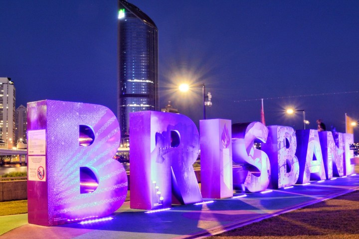 a band performing on stage in front of a building
