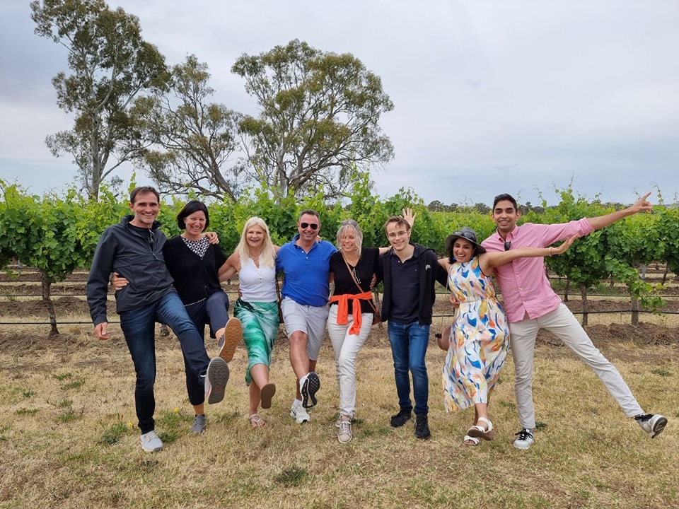 400058216_865625562229687_2932892345762867916_n a group of people standing on top of a grass covered field