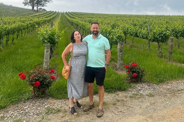 a man standing in front of a tree posing for the camera