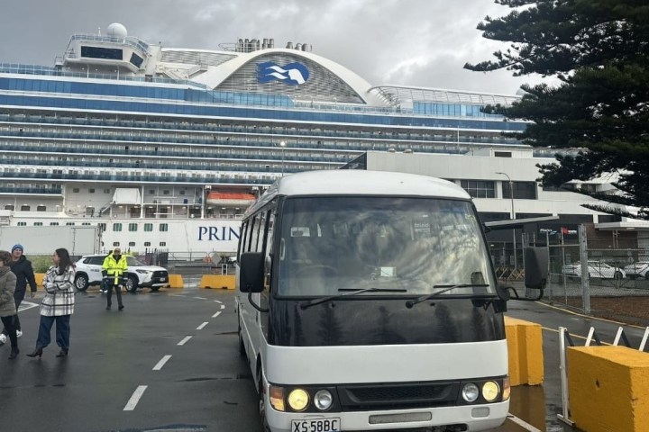 a passenger bus that is parked on the side of a road